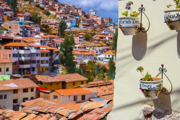 Hand-painted ceramic flower pots, with the city behind